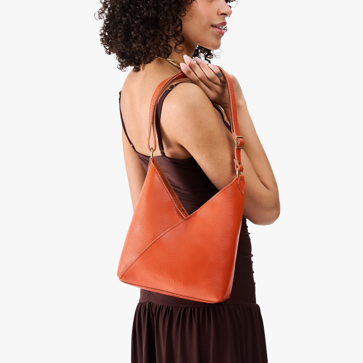 Koi*Small | Model wearing petite shoulder bag with adjustable strap and magnetic snap closure