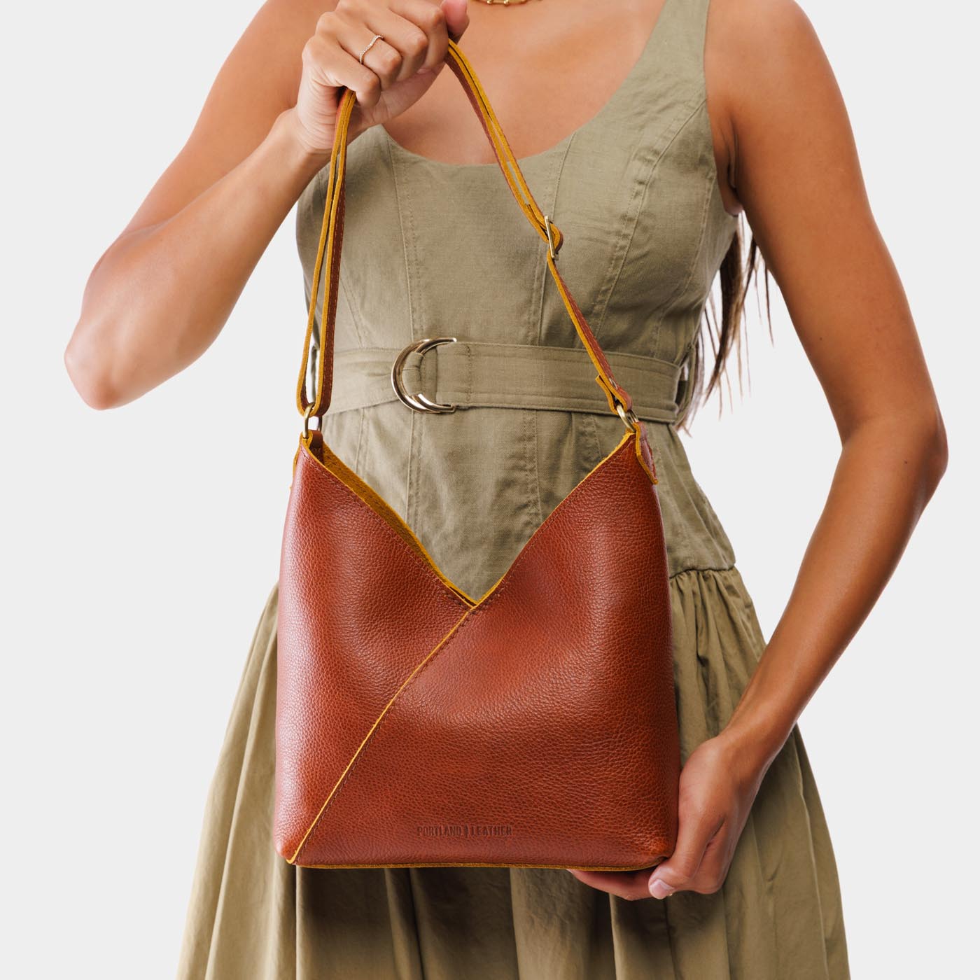Sienna*Small | Model holding petite shoulder bag with adjustable strap and magnetic snap closure