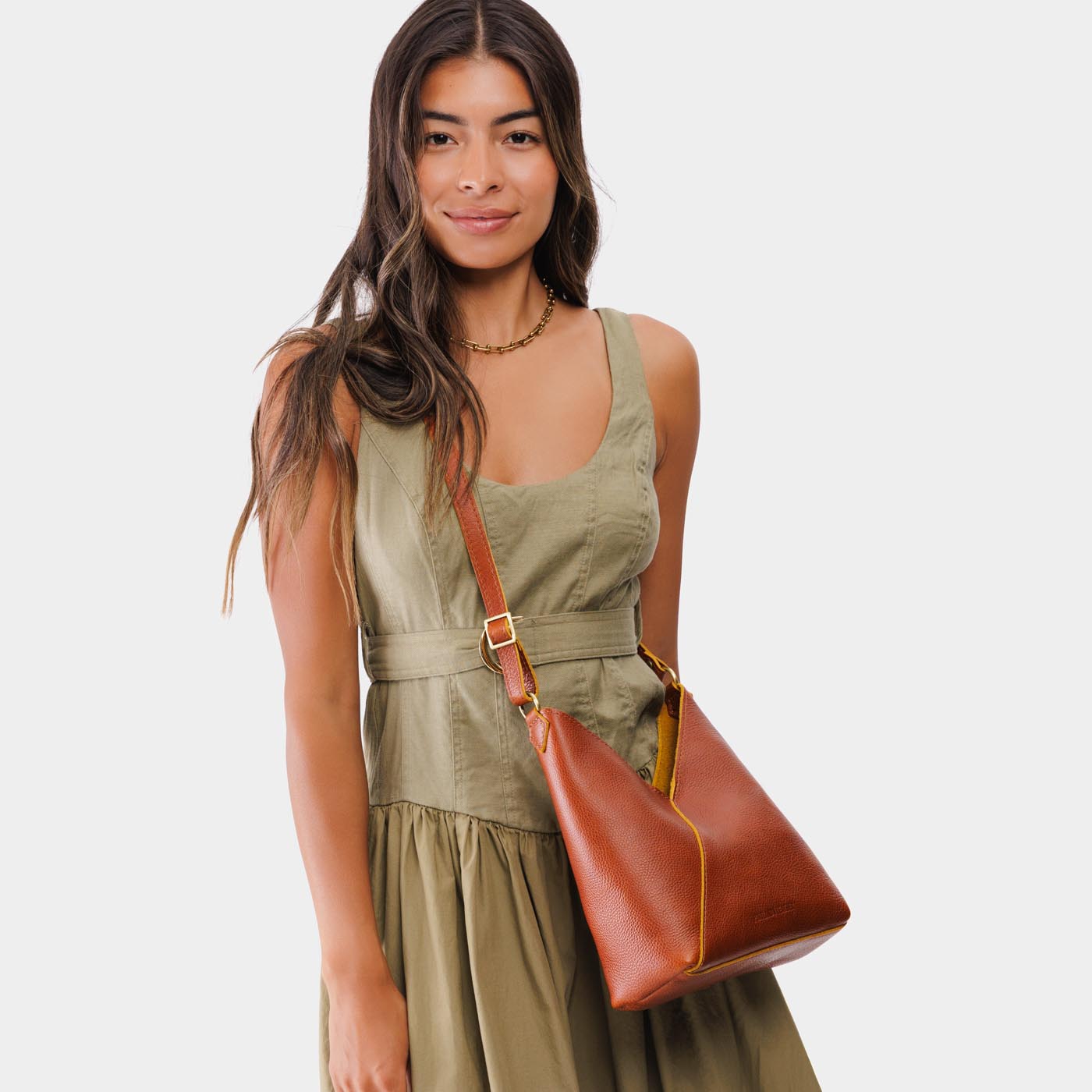 Sienna*Small | Model wearing petite shoulder bag with adjustable strap and magnetic snap closure