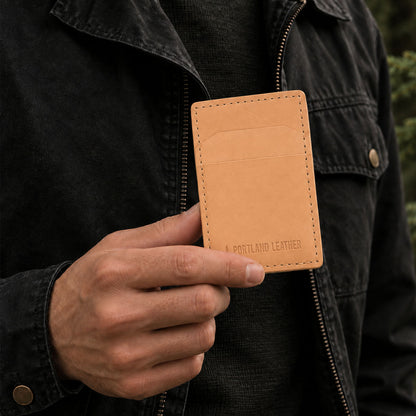 Naturale | A close-up of a person holding a tan leather card holder with the brand name 'PORTLAND LEATHER' debossed on the front.