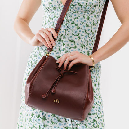 Cognac | Model wearing bucket bag with cinched drawstring closure