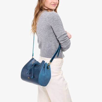Caspian | Model wearing bucket bag with cinched drawstring closure