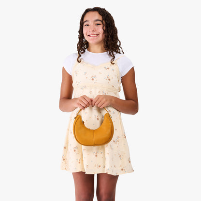 Sunshine | Model with a crescent shaped shoulder bag with zipper closure and gold accents