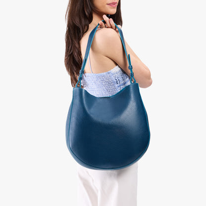Caspian*Large | Model holding round leather purse with adjustable shoulder strap