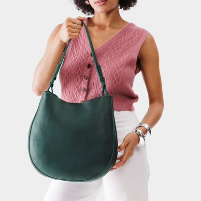 Forest Green*Large | Woman wearing rounded shoulder bag with adjustable strap on a white background