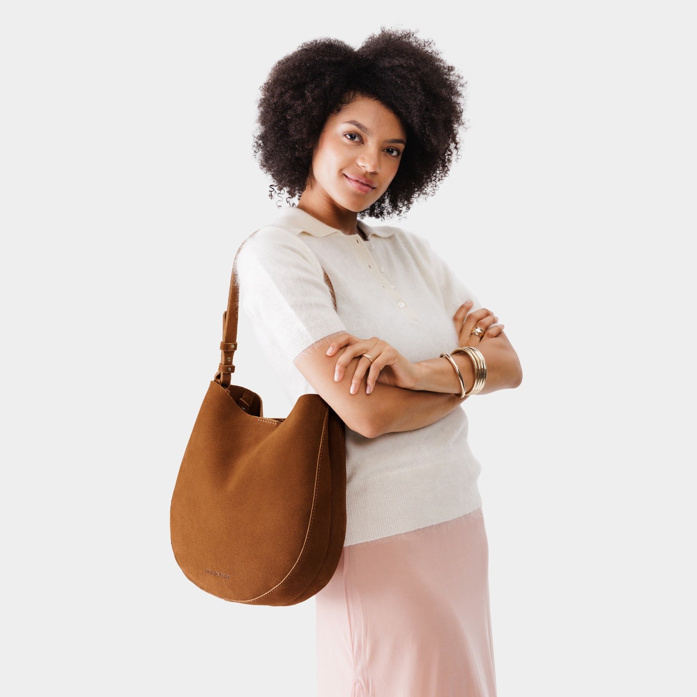 Jackson*Large | Woman wearing rounded shoulder bag with adjustable strap on a white background