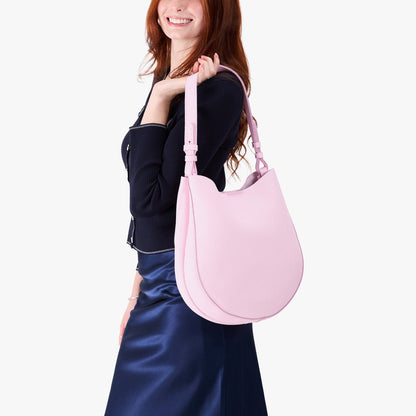 Pinkaboo*Large | Model holding round leather purse with adjustable shoulder strap