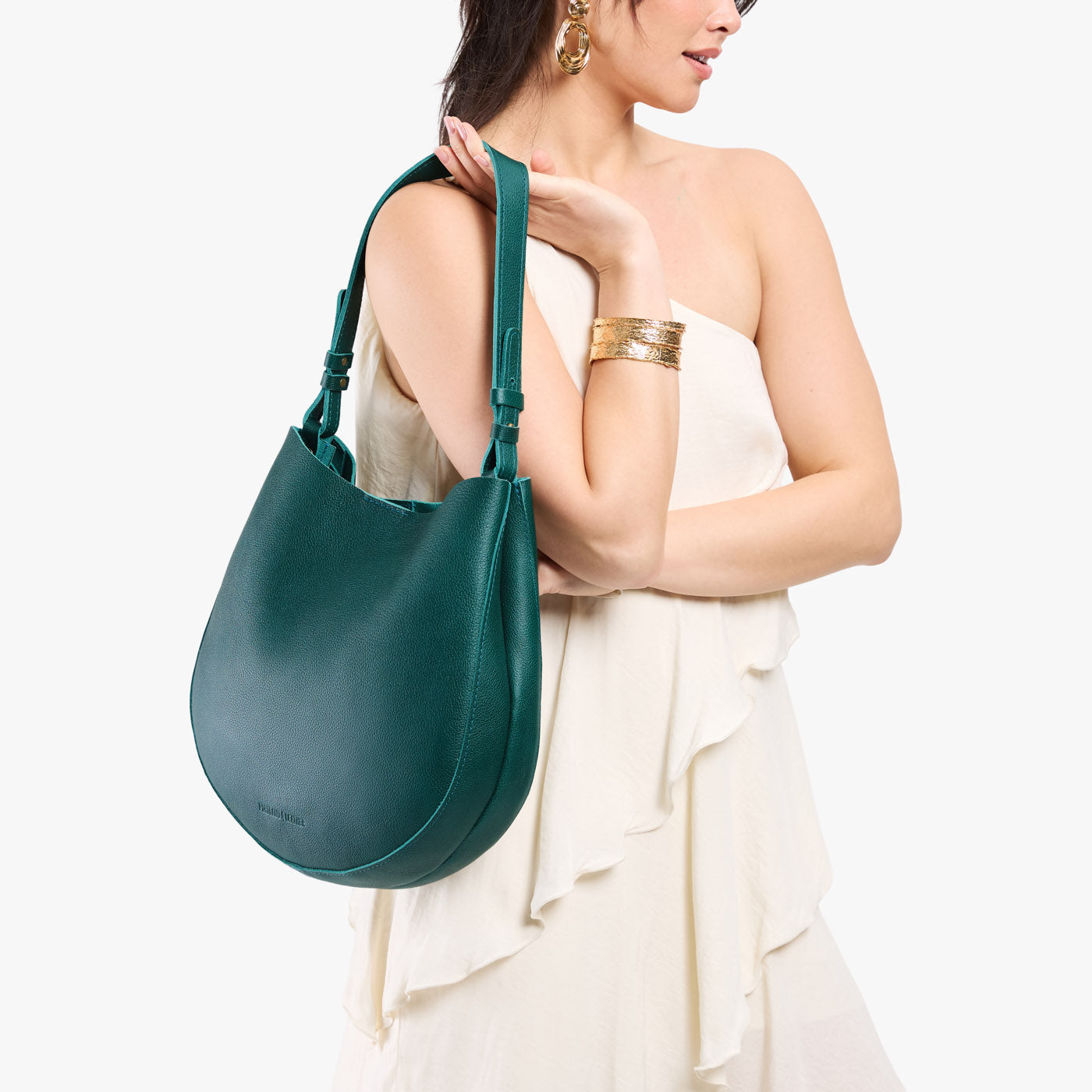 Sea Glass*Large | Model holding round leather purse with adjustable shoulder strap