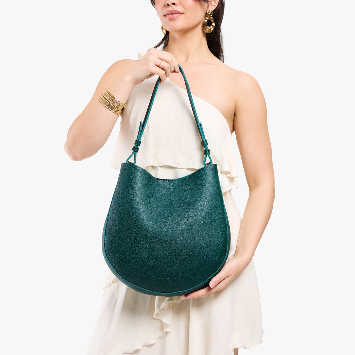 Sea Glass*Large | Model holding round leather purse with adjustable shoulder strap