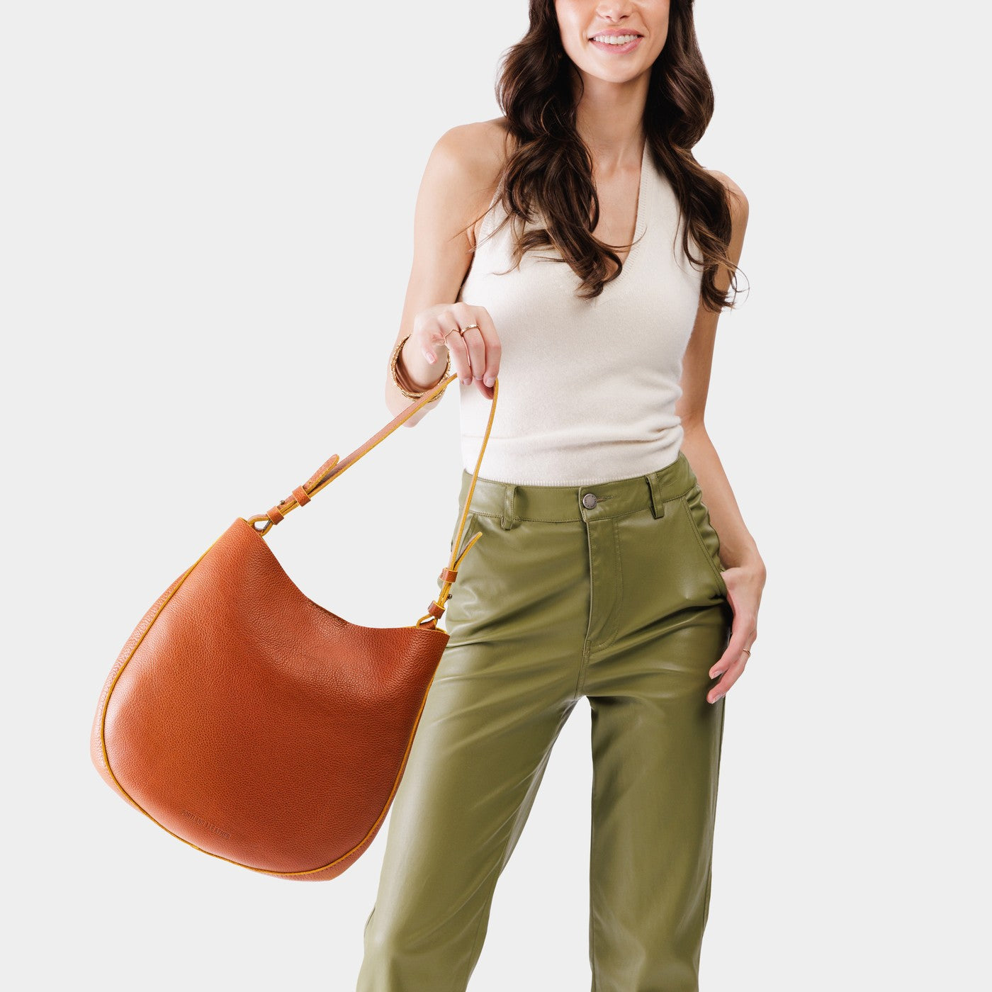 Sienna*Large | Woman wearing rounded shoulder bag with adjustable strap on a white background