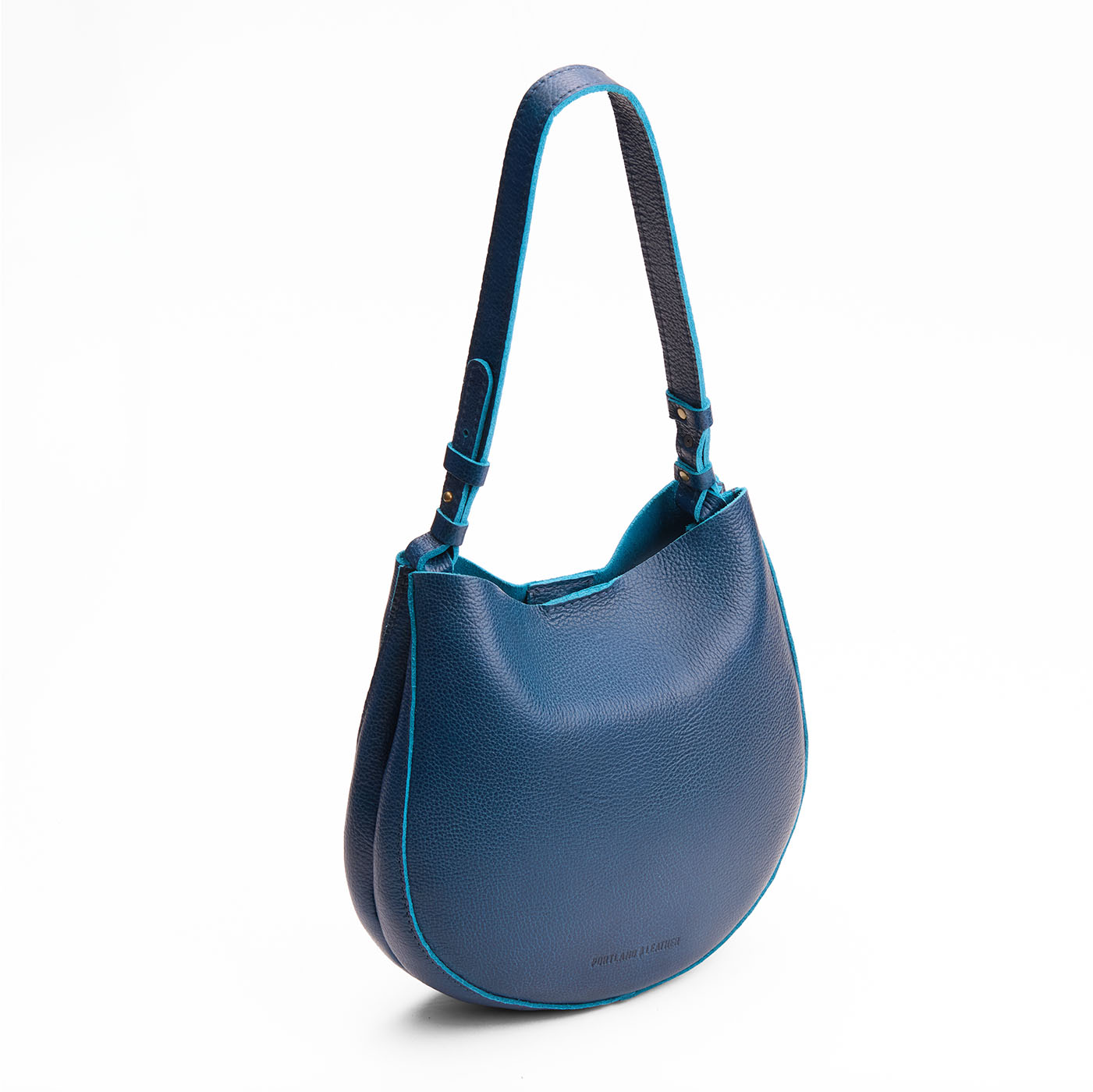 Caspian*Medium | Rounded shoulder bag with adjustable strap on a white background
