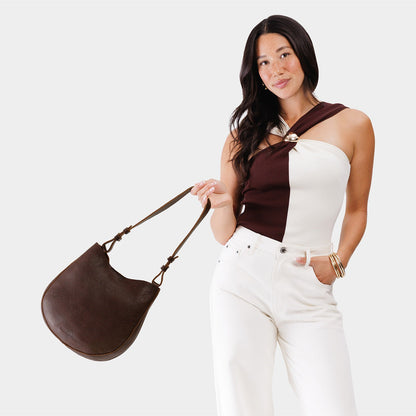 Coldbrew*Medium | Woman wearing rounded shoulder bag with adjustable strap on a white background