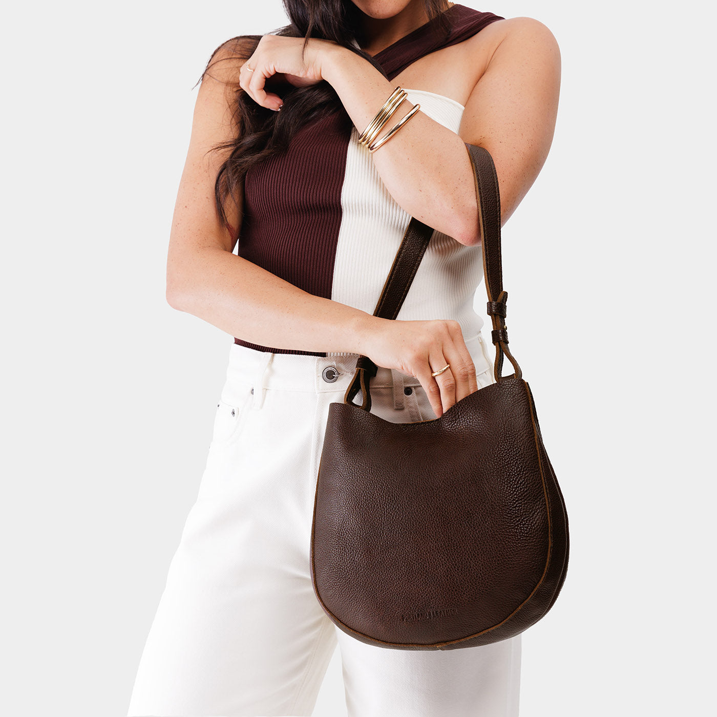 Coldbrew*Medium | Woman wearing rounded shoulder bag with adjustable strap on a white background