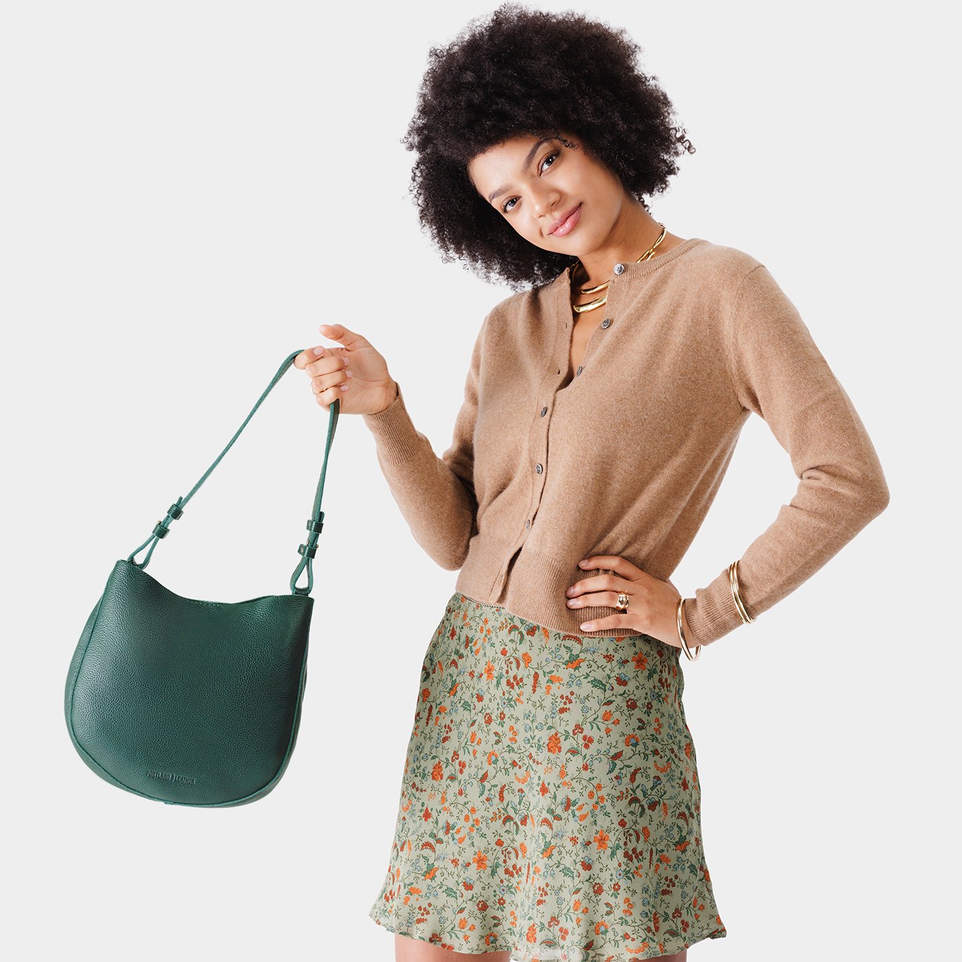 Forest Green*Medium | Woman wearing rounded shoulder bag with adjustable strap on a white background