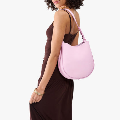 Pinkaboo*Medium | Model carrying round leather purse with adjustable shoulder strap