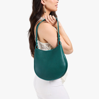 Sea Glass*Medium | Model carrying round leather purse with adjustable shoulder strap