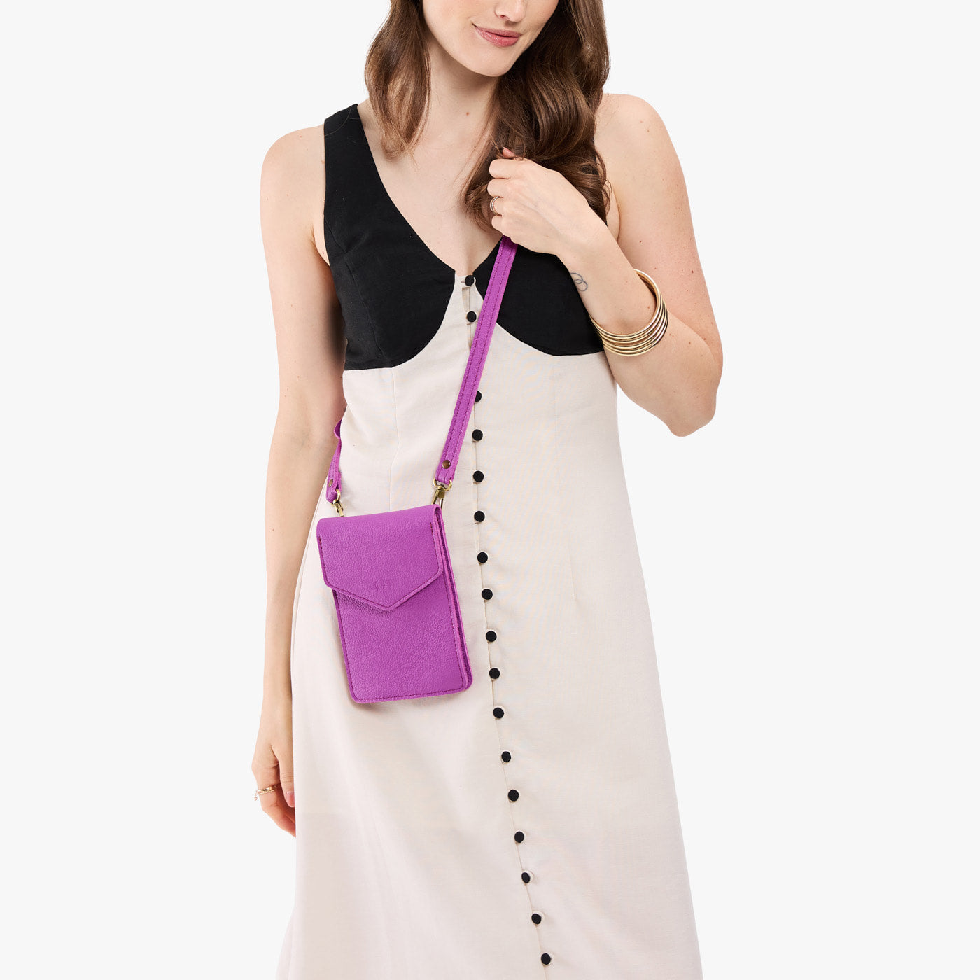 Cattleya | Model wearing slim, phone-shaped crossbody purse with magnetic closure