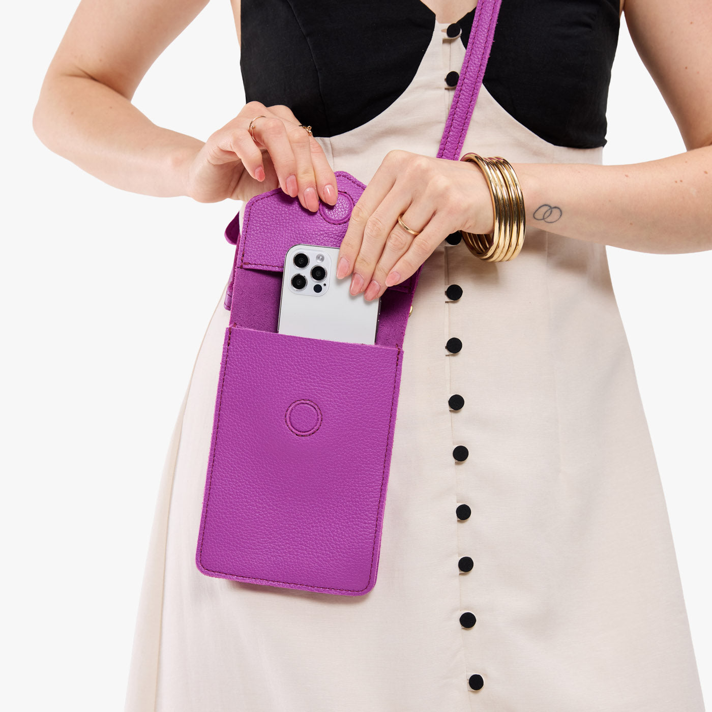 Cattleya | Model wearing slim, phone-shaped crossbody purse with magnetic closure