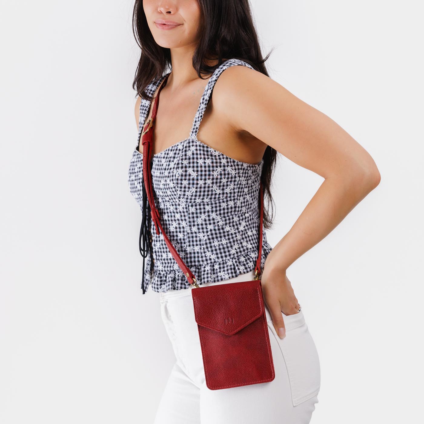 Chili Red | Model wearing slim, phone-shaped crossbody purse with magnetic closure