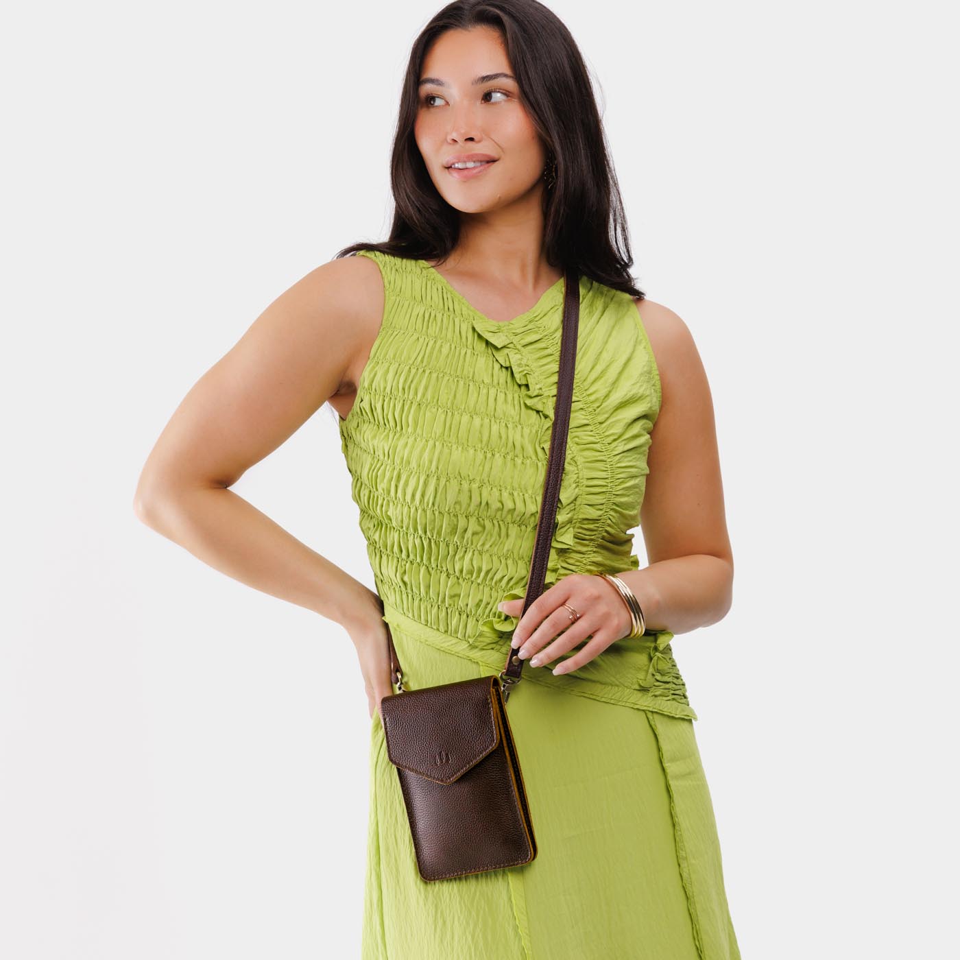 Coldbrew | Model wearing slim, phone-shaped crossbody purse with magnetic closure