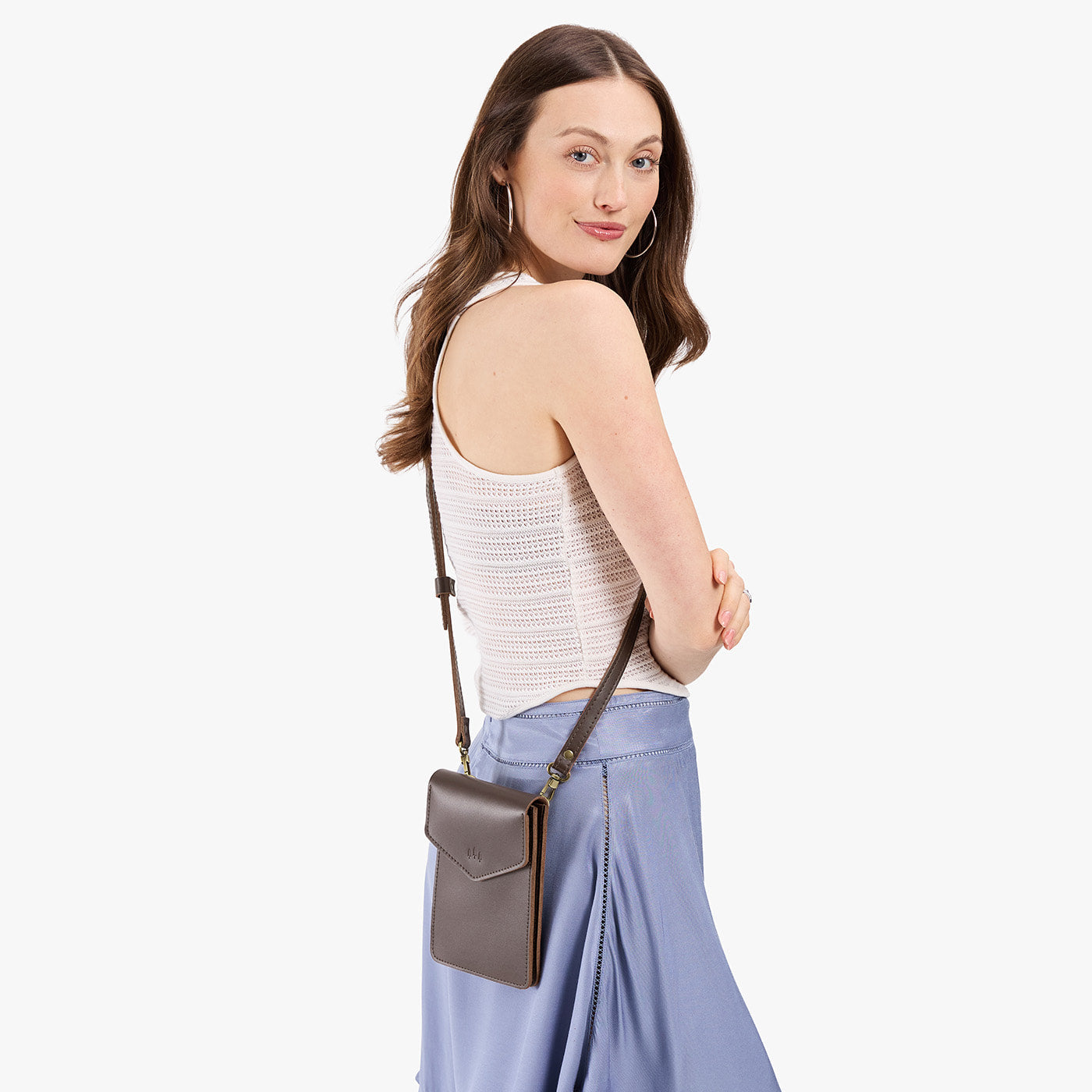 Grizzly | Model wearing slim, phone-shaped crossbody purse with magnetic closure