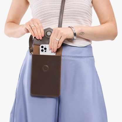 Grizzly | Model wearing slim, phone-shaped crossbody purse with magnetic closure