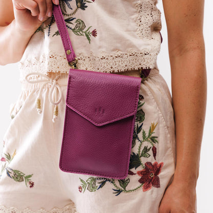 Iris | Model wearing slim, phone-shaped crossbody purse with magnetic closure