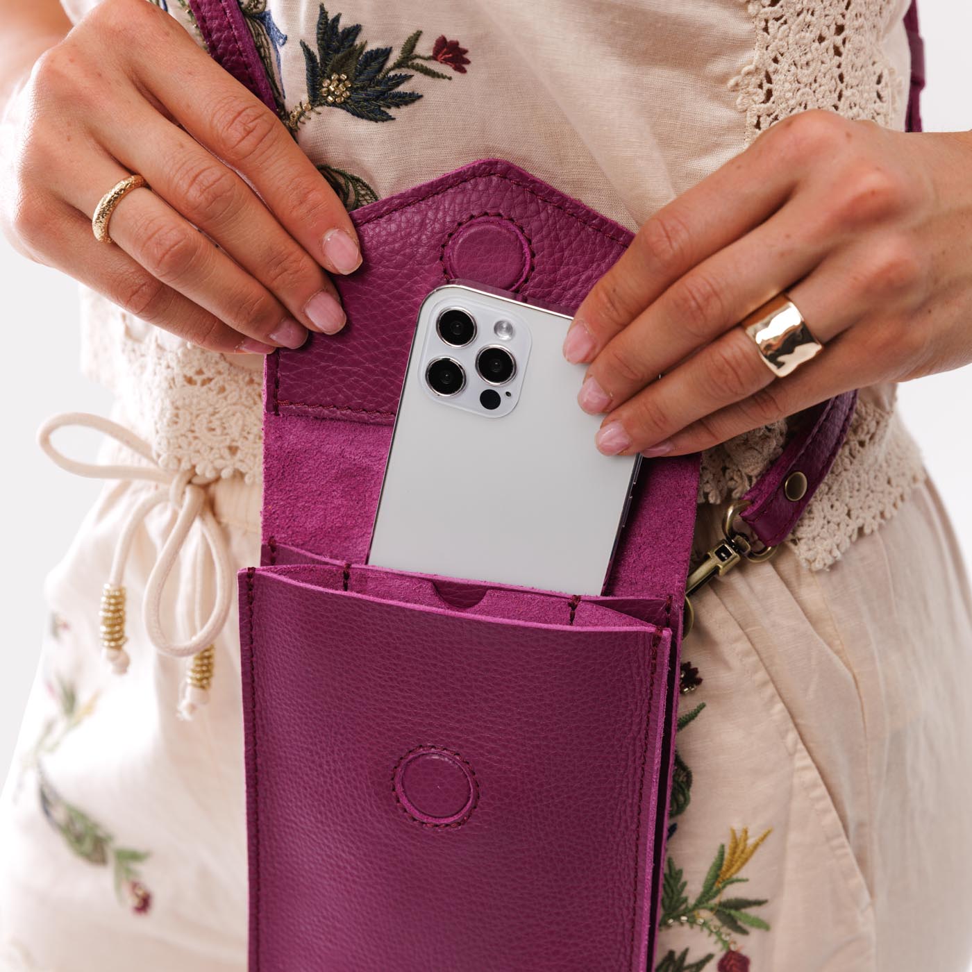 Iris | Model wearing slim, phone-shaped crossbody purse with magnetic closure