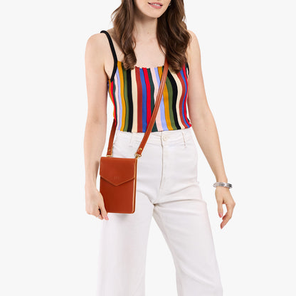 Madrone | Model wearing slim, phone-shaped crossbody purse with magnetic closure