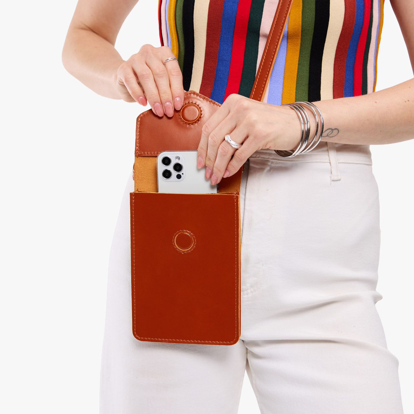 Madrone | Model wearing slim, phone-shaped crossbody purse with magnetic closure