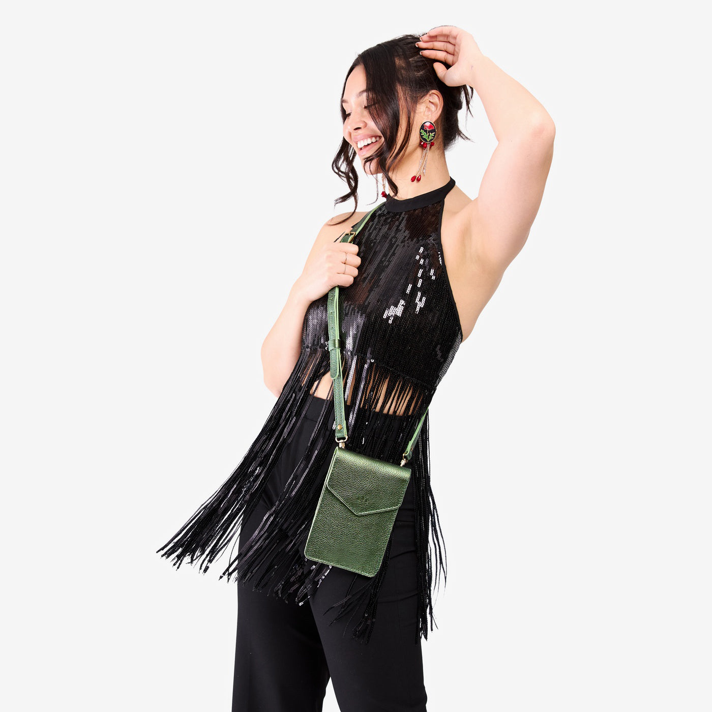 Metallic Greench | Model wearing slim, phone-shaped crossbody purse with magnetic closure