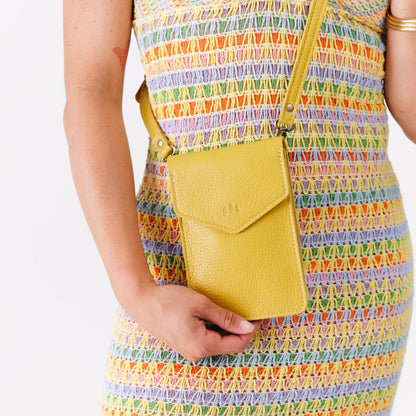 Naples | Model wearing slim, phone-shaped crossbody purse with magnetic closure