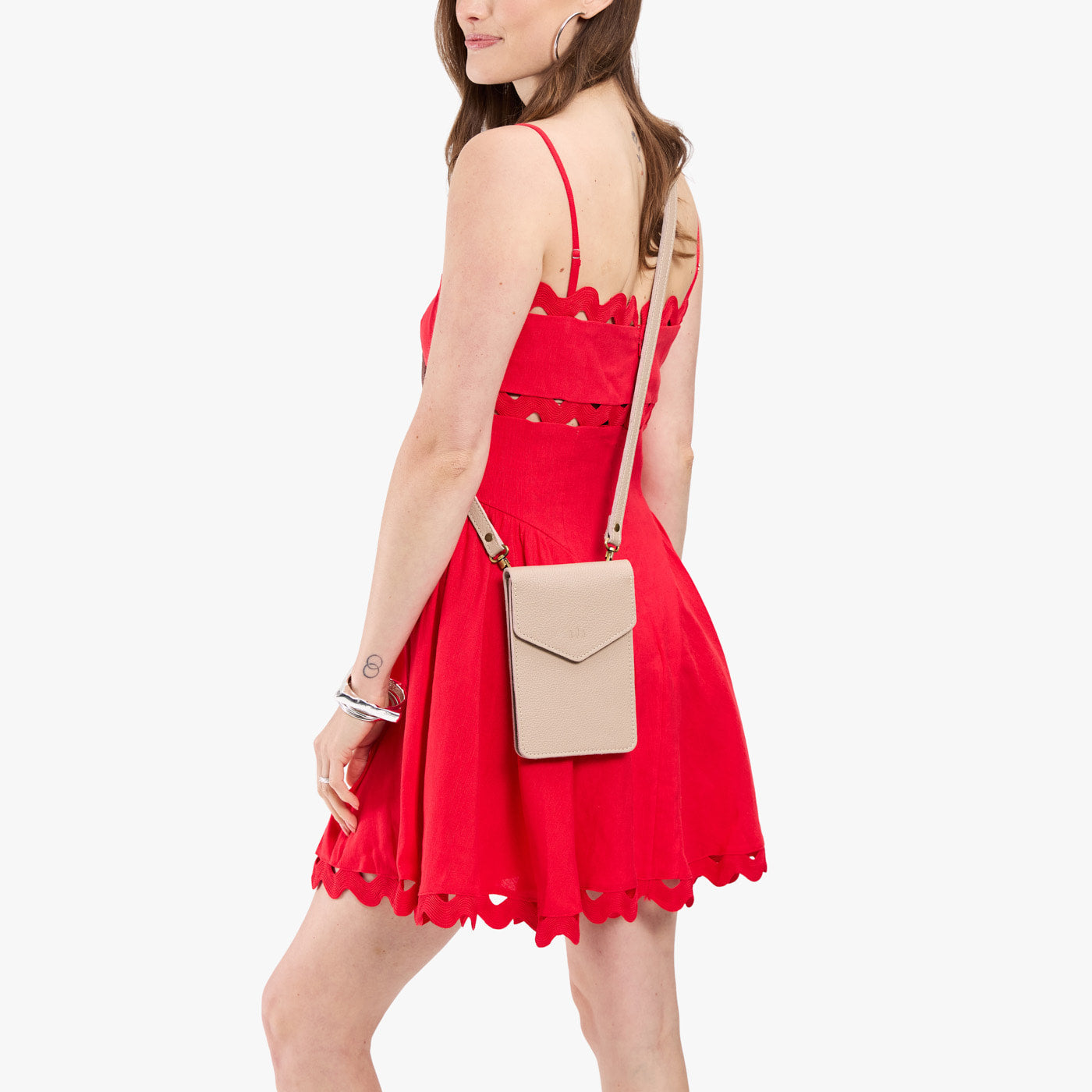 Oatmilk | Model wearing slim, phone-shaped crossbody purse with magnetic closure