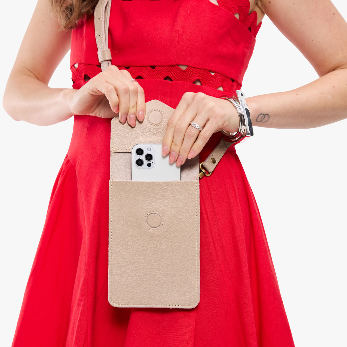 Oatmilk | Model wearing slim, phone-shaped crossbody purse with magnetic closure