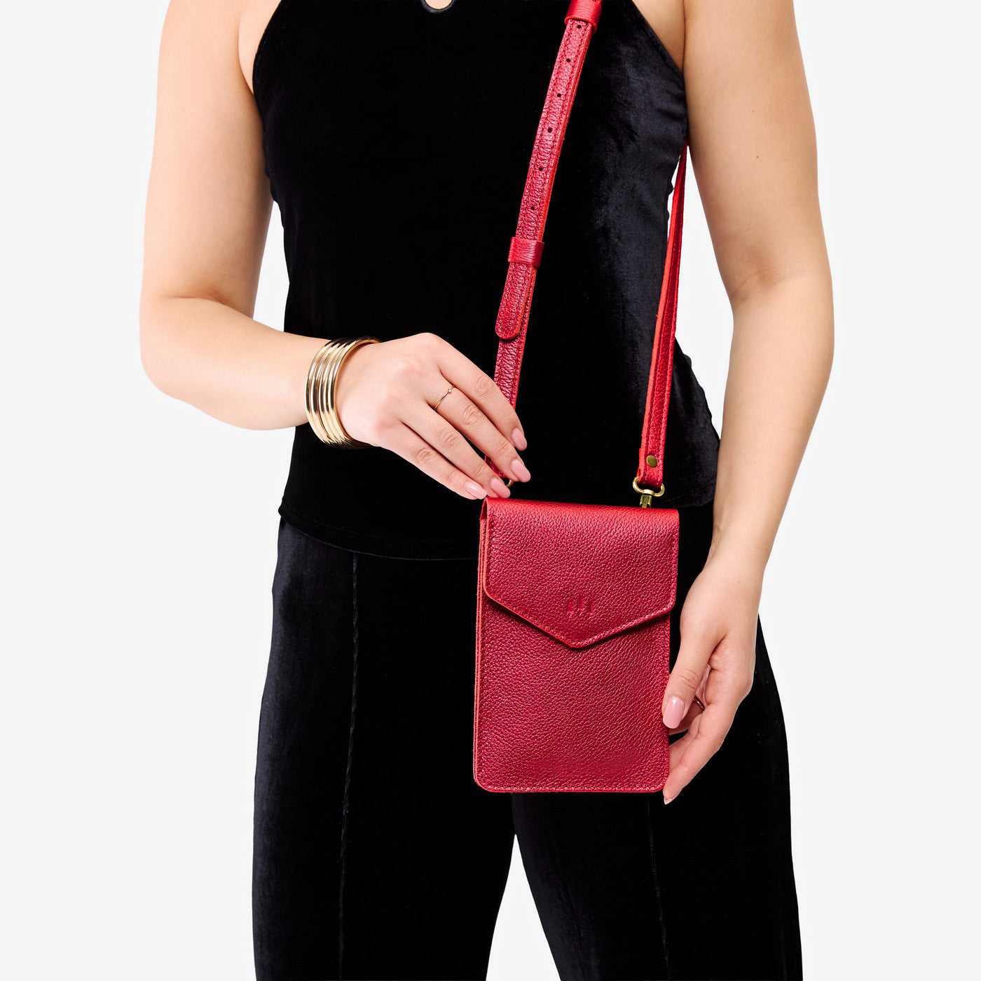 Reba Red | Model wearing slim, phone-shaped crossbody purse with magnetic closure