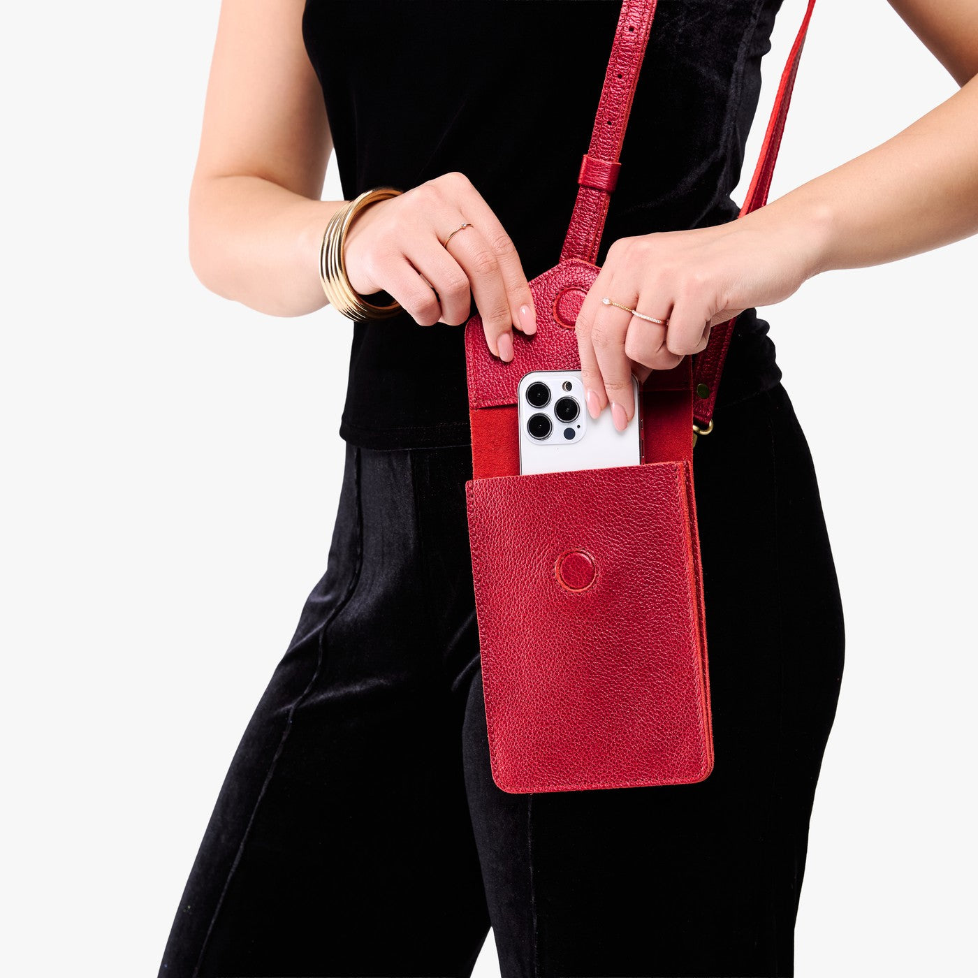 Reba Red | Model wearing slim, phone-shaped crossbody purse with magnetic closure