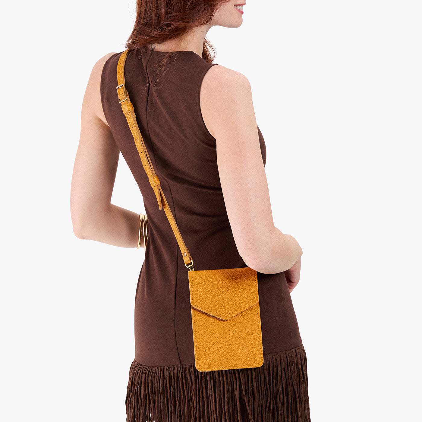 Sunshine | Model wearing slim, phone-shaped crossbody purse with magnetic closure