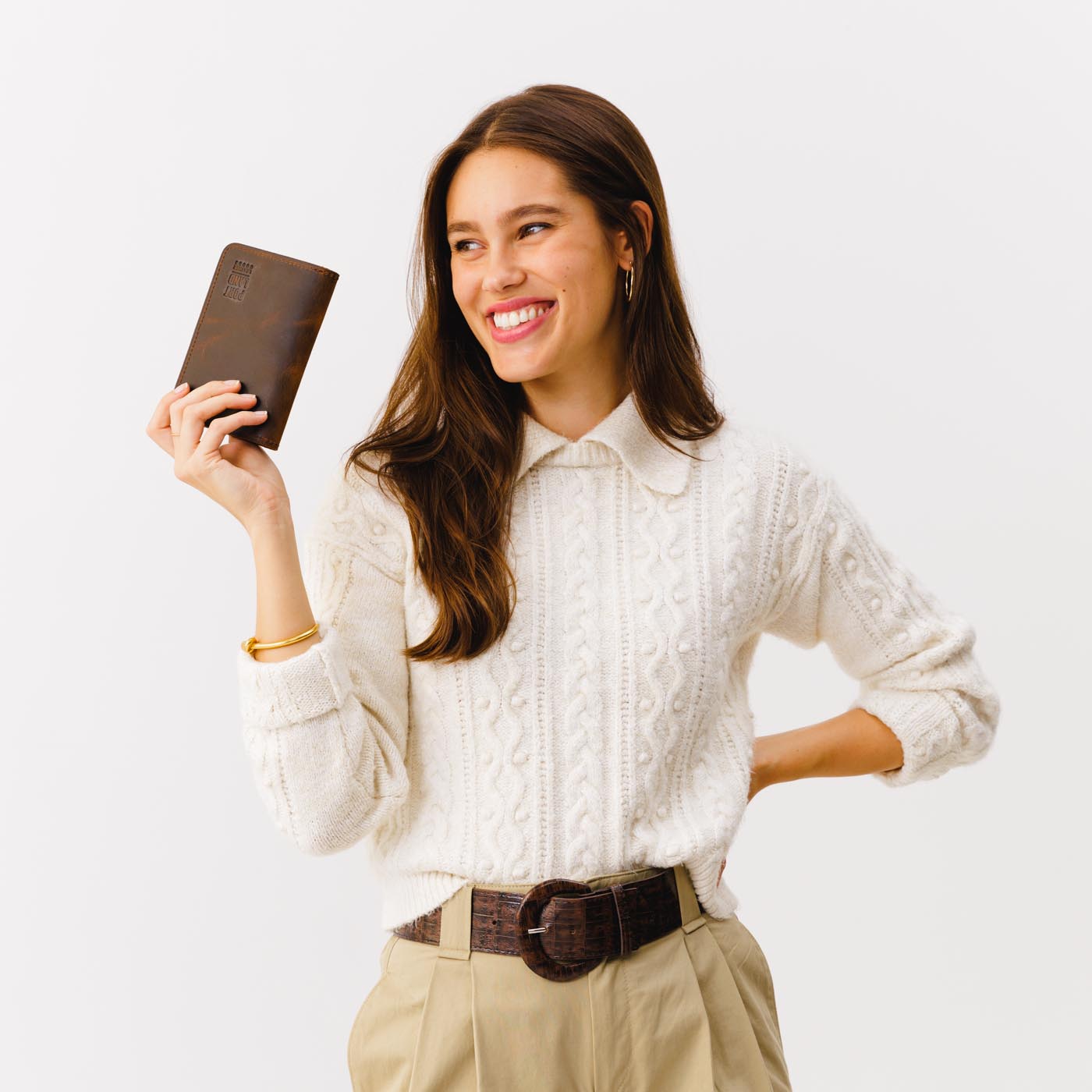 Canyon | Model holding leather passport case with PLG logo