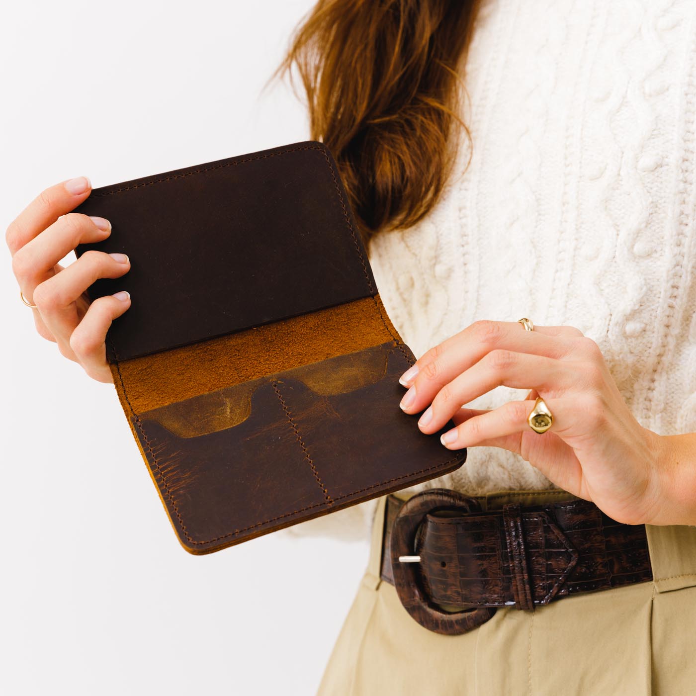 Canyon | Model holding leather passport case with PLG logo