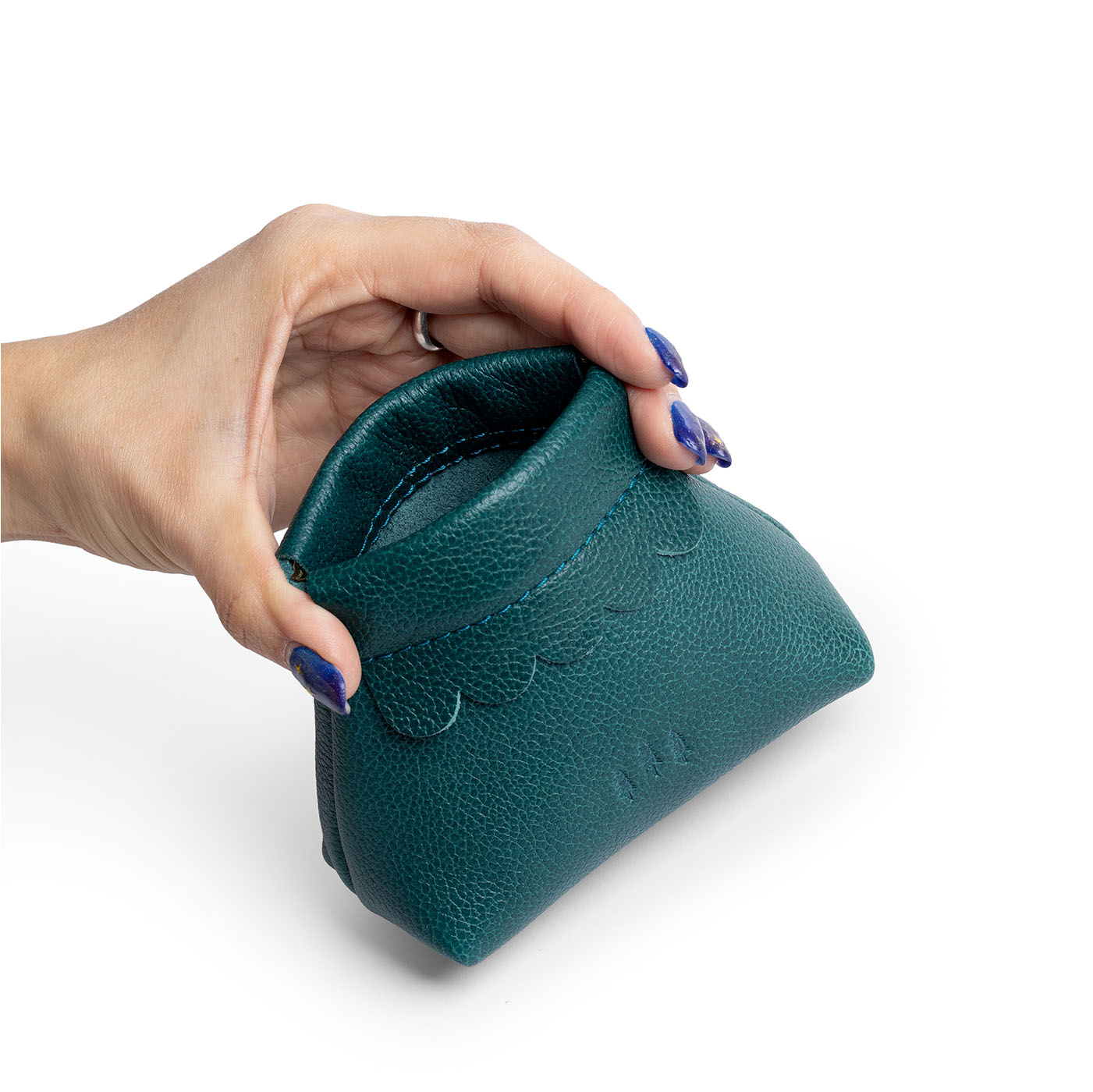 Sea Glass | Hand holding leather coin pouch with scalloped edge and three Portland leather tree emblems open