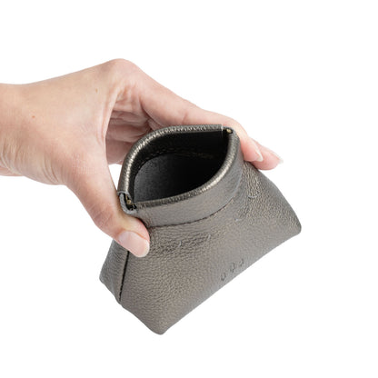 Stardust | Hand holding leather coin pouch with scalloped edge and three Portland leather tree emblems open