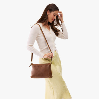 Asheville*Large | Model wearing a zip top crossbody bag with detachable strap