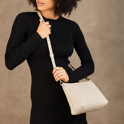 Pebbled Bone*Large | Model wearing a zip top crossbody bag with detachable strap