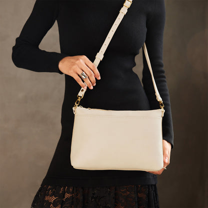 Pebbled Bone*Large | Model wearing a zip top crossbody bag with detachable strap