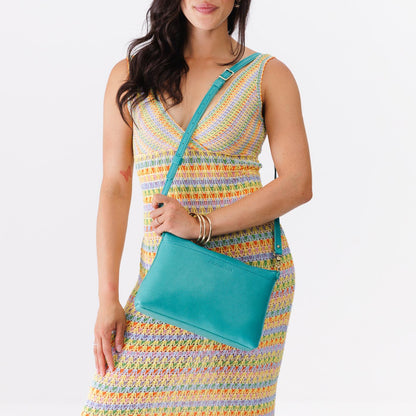Seafoam*Large | Model holding a zip top crossbody bag with detachable strap