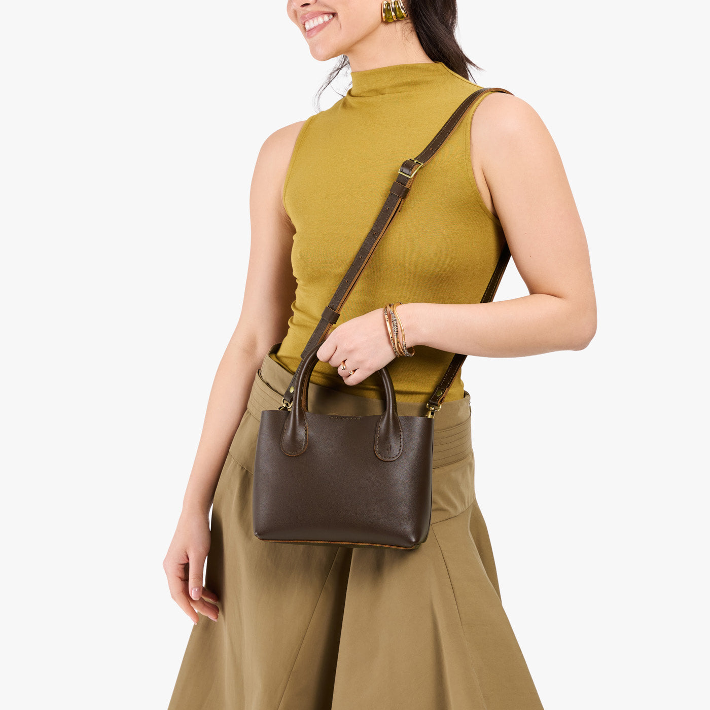 Grizzly*Small | Model holding petite tote purse with structured leather handles and crossbody strap
