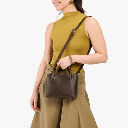 Grizzly*Small | Model holding petite tote purse with structured leather handles and crossbody strap