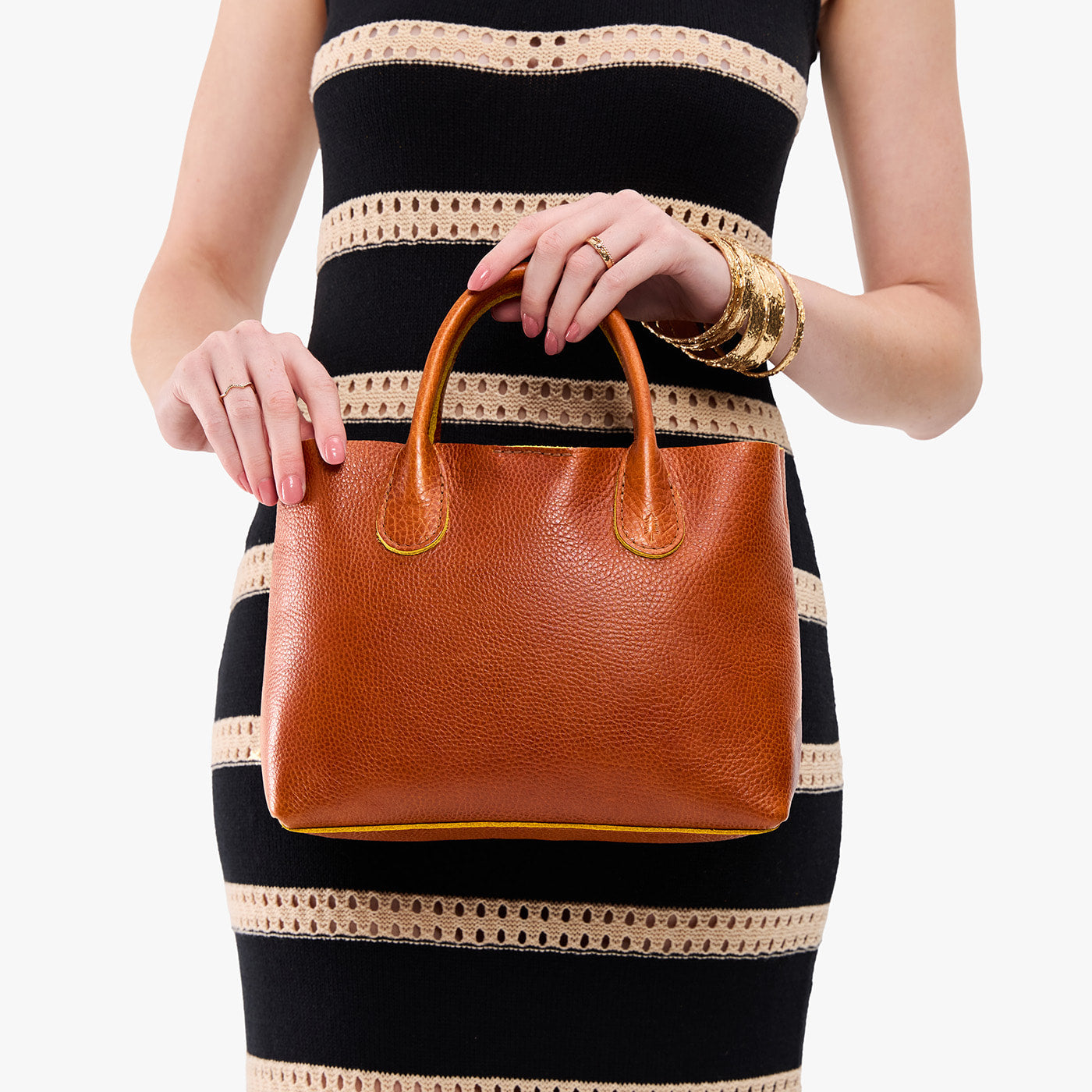 Sienna*Large | Model wearing a mid-size tote purse with structured leather handles and crossbody strap