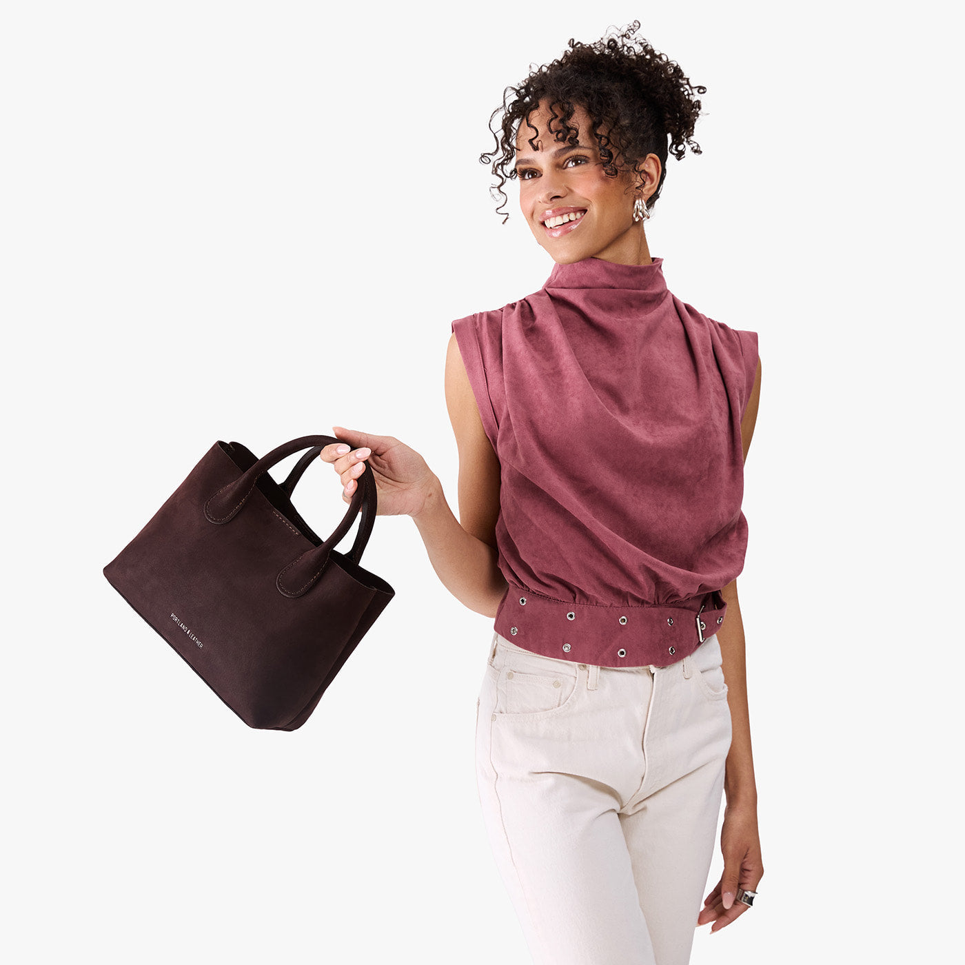 Velvet Brown*Large | Model holding mid-size tote purse with structured leather handles and crossbody strap