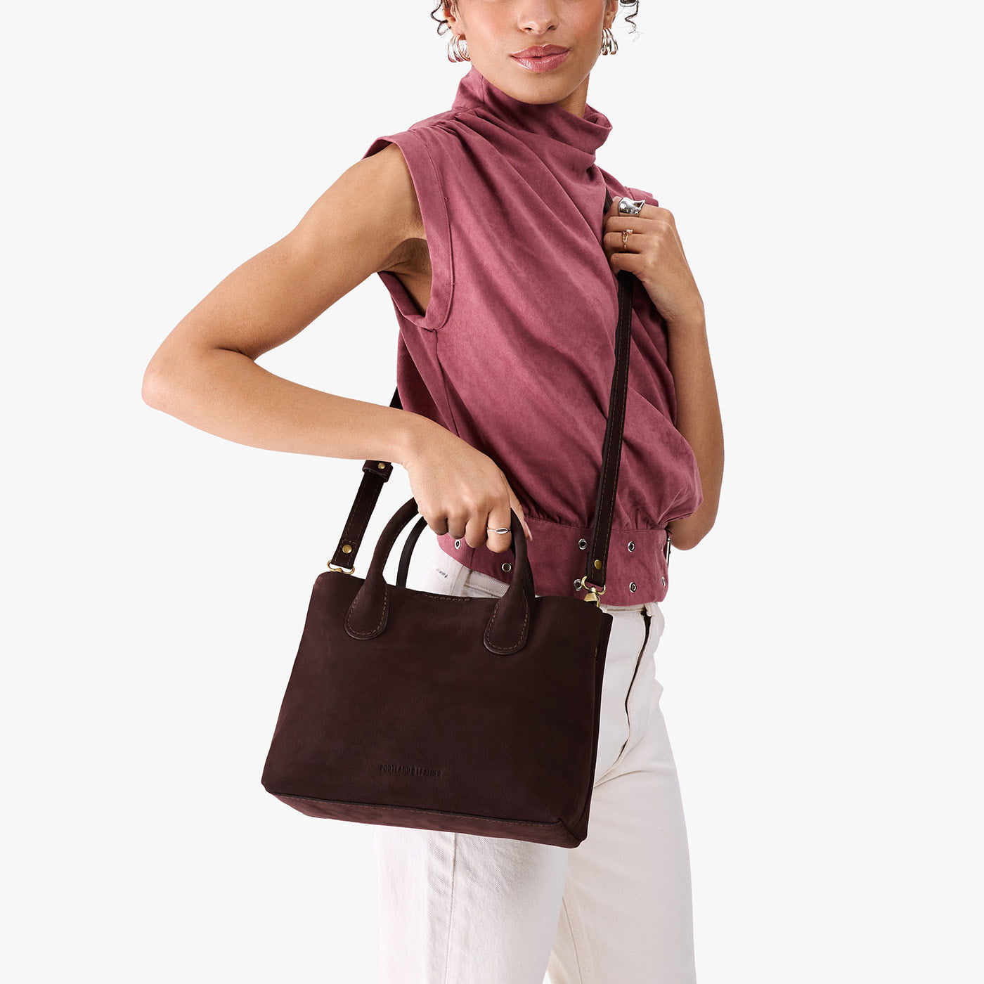 Velvet Brown*Large | Model holding mid-size tote purse with structured leather handles and crossbody strap